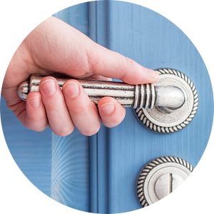 photo of a hand on a door handle